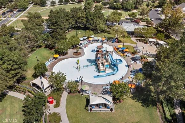 an aerial view of a house with a swimming pool and outdoor seating