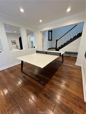 a spacious bedroom with wooden floor and furniture