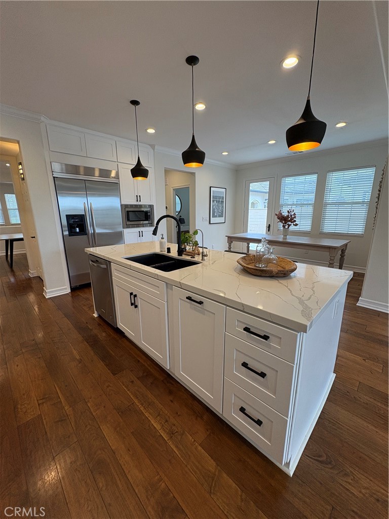 72 Downing Street Ladera Ranch, CA 92694 - Photo 7 of 24 a kitchen with stainless steel appliances granite countertop a sink a stove and a wooden floors
