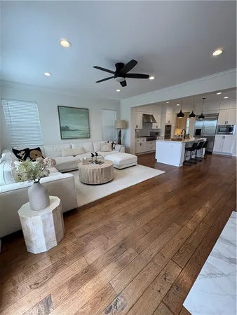a living room with furniture and a wooden floor