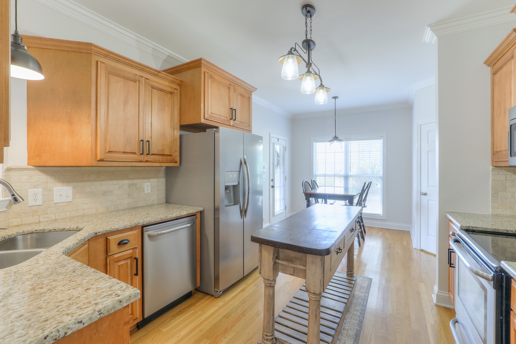 711 Heritage Road Lebanon, TN 37087 - Photo 18 of 49 a kitchen with stainless steel appliances granite countertop a refrigerator a sink dishwasher a stove and white countertops with wooden floor
