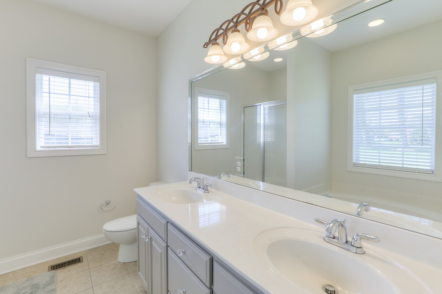711 Heritage Road Lebanon, TN 37087 - Photo 26 of 49 a bathroom with a toilet a sink and mirror