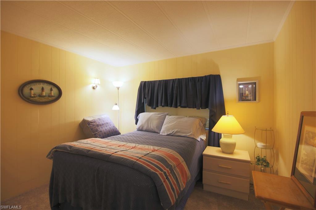 883 Manatee Road Naples, FL 34114 - Photo 12 of 15 a bedroom with a bed and wall painting