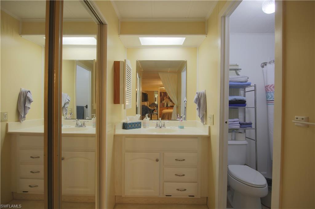883 Manatee Road Naples, FL 34114 - Photo 15 of 15 a bathroom with a sink a toilet and shower