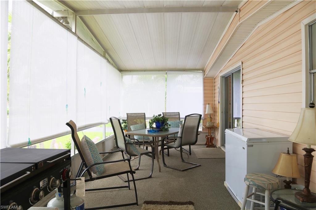 883 Manatee Road Naples, FL 34114 - Photo 7 of 15 a view of a patio with table and chairs and potted plants