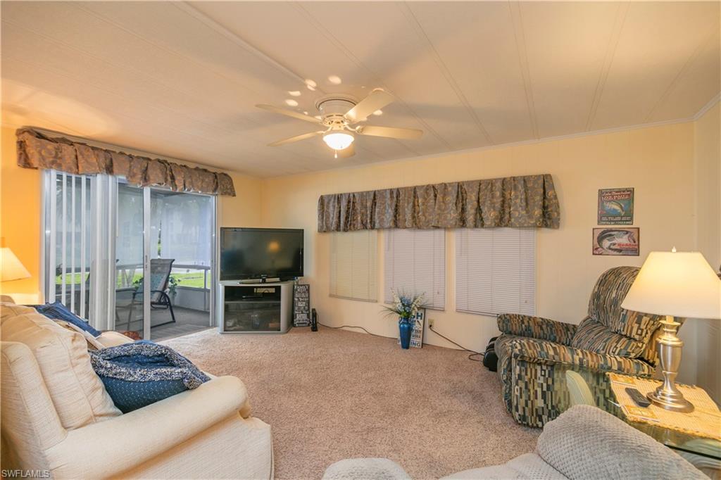 883 Manatee Road Naples, FL 34114 - Photo 10 of 15 a living room with furniture and a flat screen tv