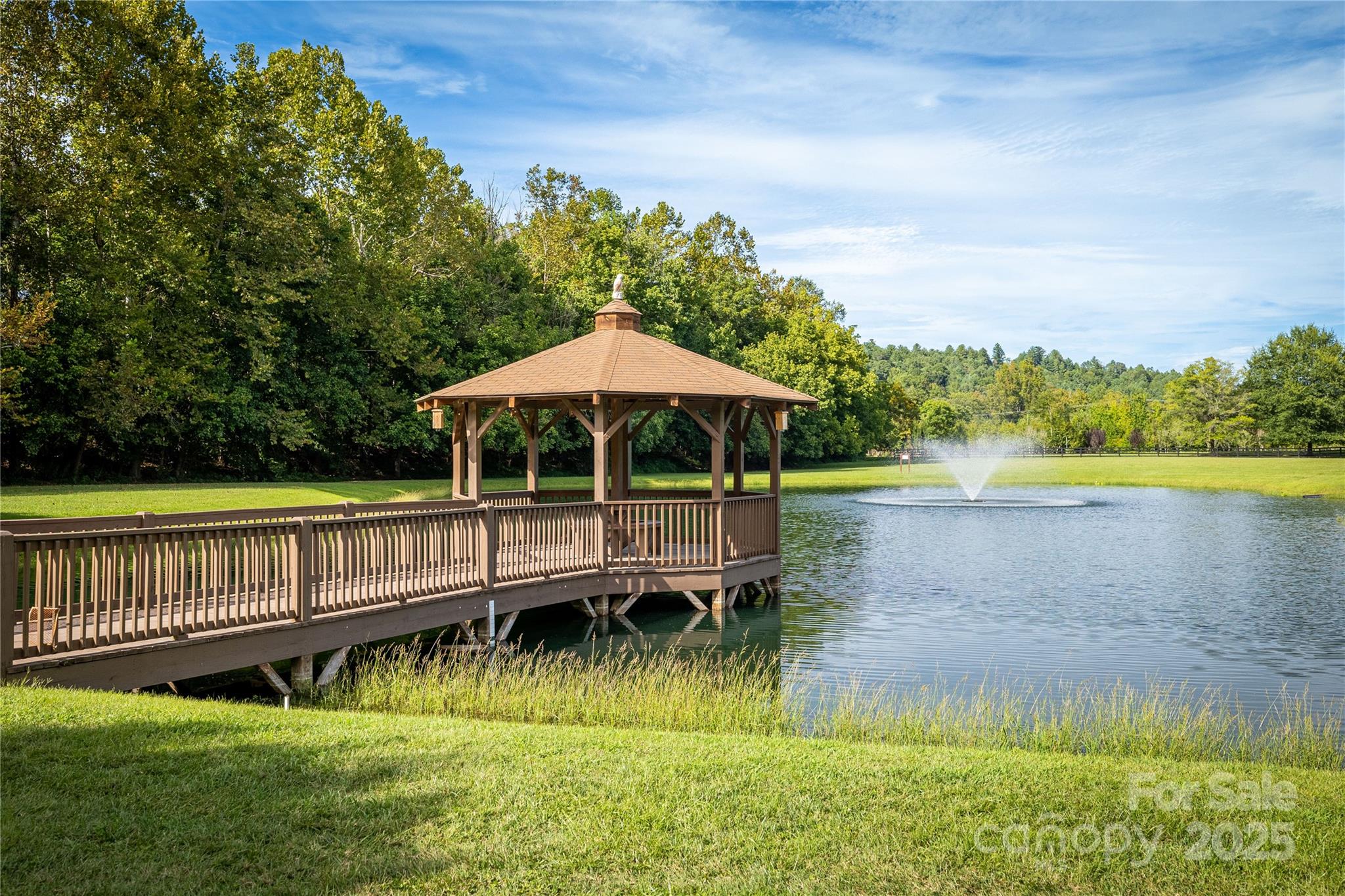 1038 Round Rock Road, Unit 49/50 Lenoir, NC 28645 - Photo 46 of 46 a view of a garden with a bench in a lake