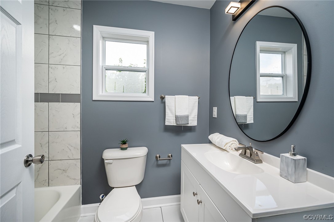 706 Rome Street Petersburg, VA 23803 - Photo 12 of 26 a bathroom with a toilet sink and mirror