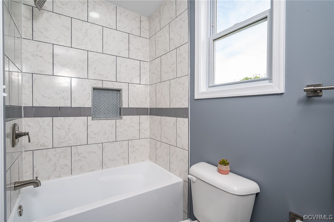 706 Rome Street Petersburg, VA 23803 - Photo 15 of 26 a white bath tub sitting next to a white toilet