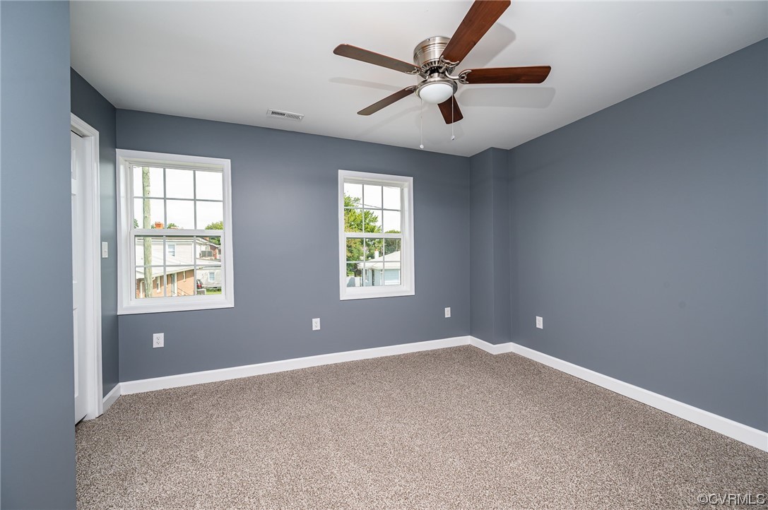 706 Rome Street Petersburg, VA 23803 - Photo 22 of 26 a view of a big room with windows and chandelier fan