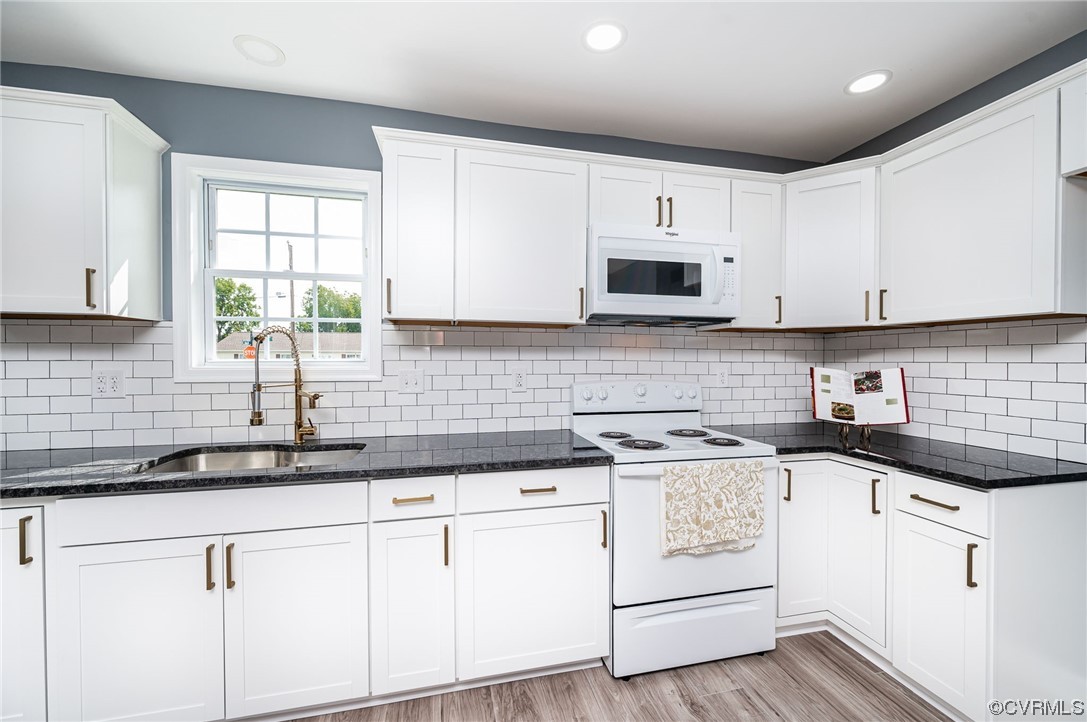 706 Rome Street Petersburg, VA 23803 - Photo 10 of 26 a kitchen with granite countertop white cabinets white appliances and a sink