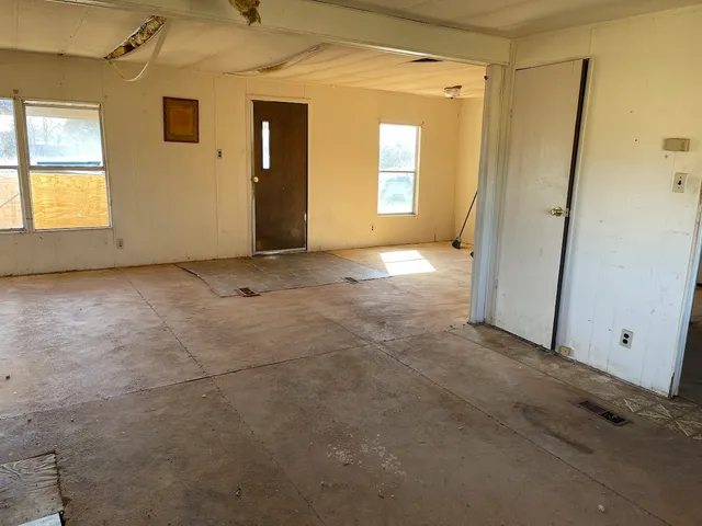 an empty room with windows and closet