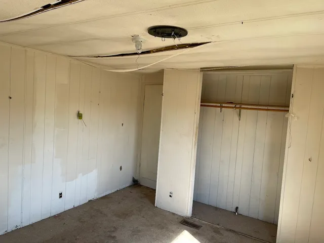 a view of a room with a wooden door