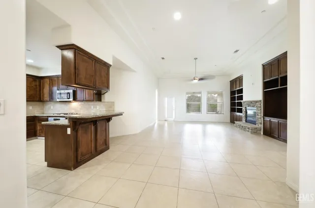 a kitchen with stainless steel appliances granite countertop a stove a sink and a microwave