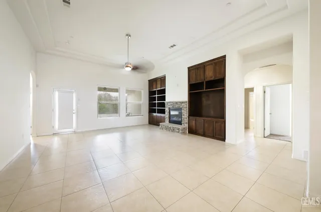 an empty room with furniture and a kitchen