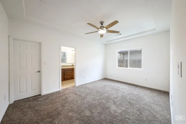 a view of empty room with ceiling fan