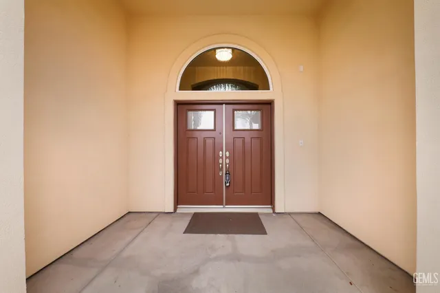 a view of a door of a house with a yard