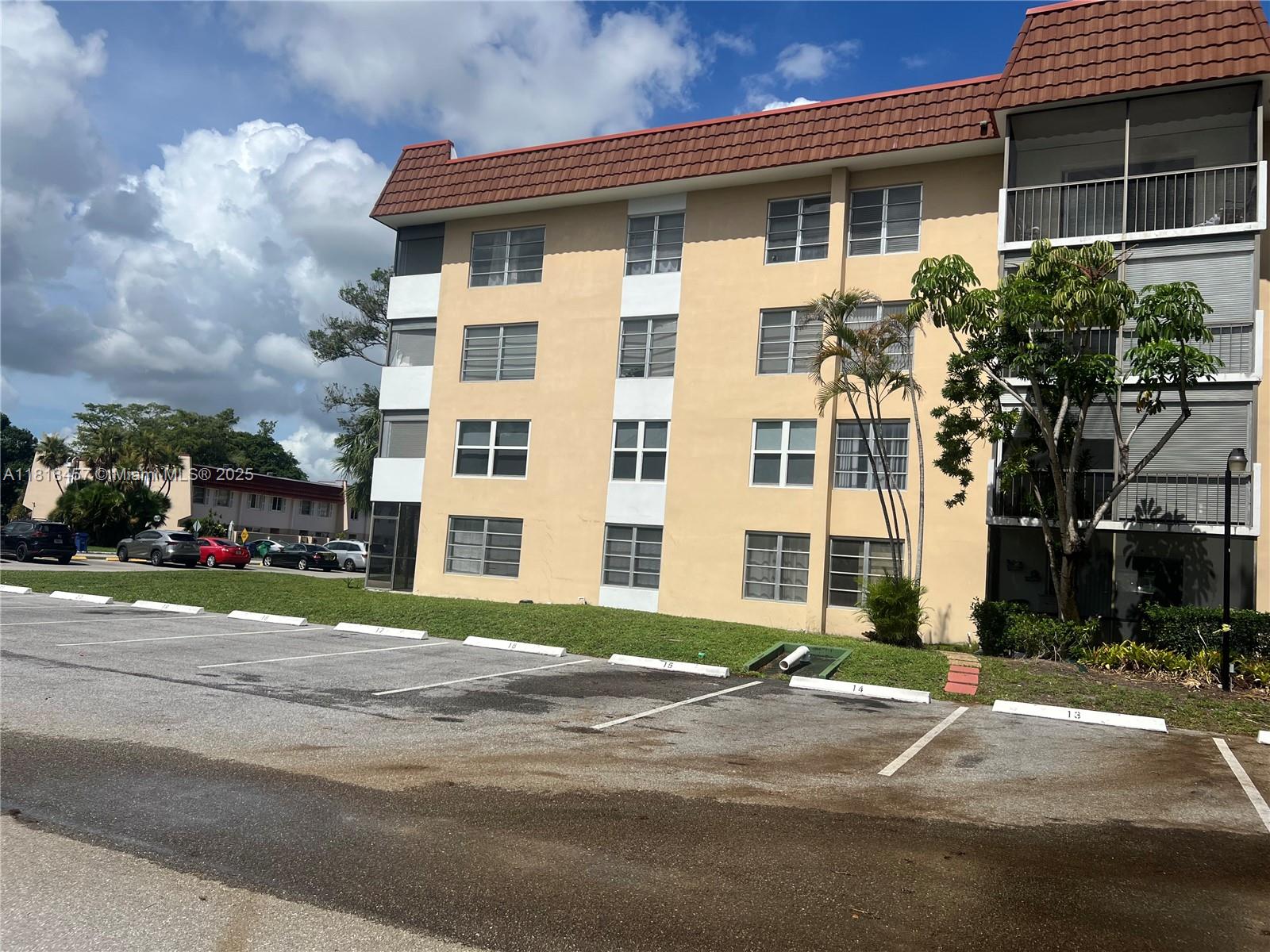 4156 Inverrary Drive, Unit 309 Lauderhill, FL 33319 - Photo 2 of 16 a view of a building with a street
