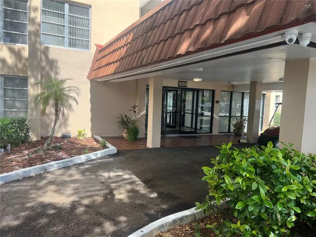 a view of a house with potted plants