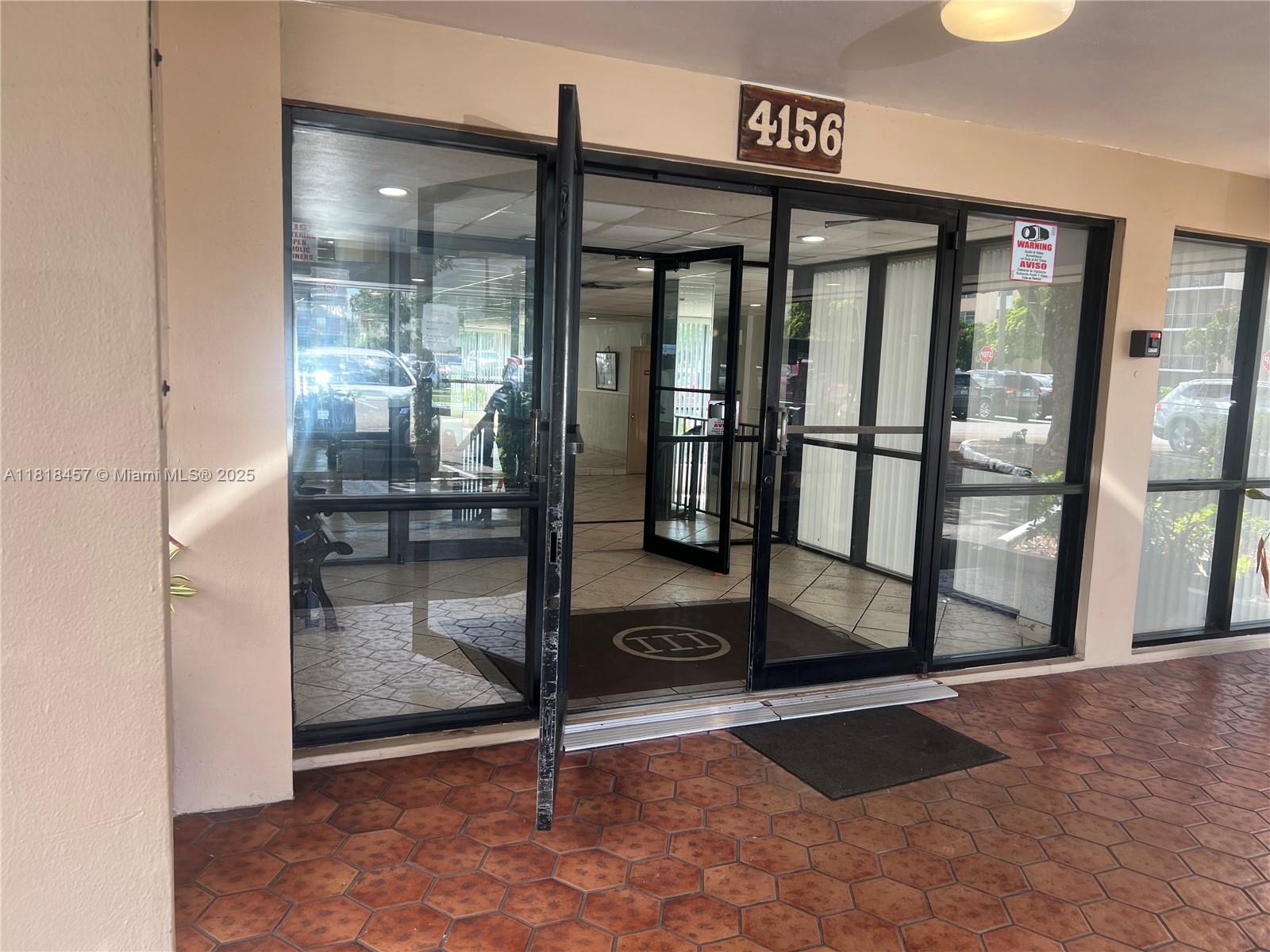 4156 Inverrary Drive, Unit 309 Lauderhill, FL 33319 - Photo 4 of 16 a view of a livingroom with a glass door and an entryway