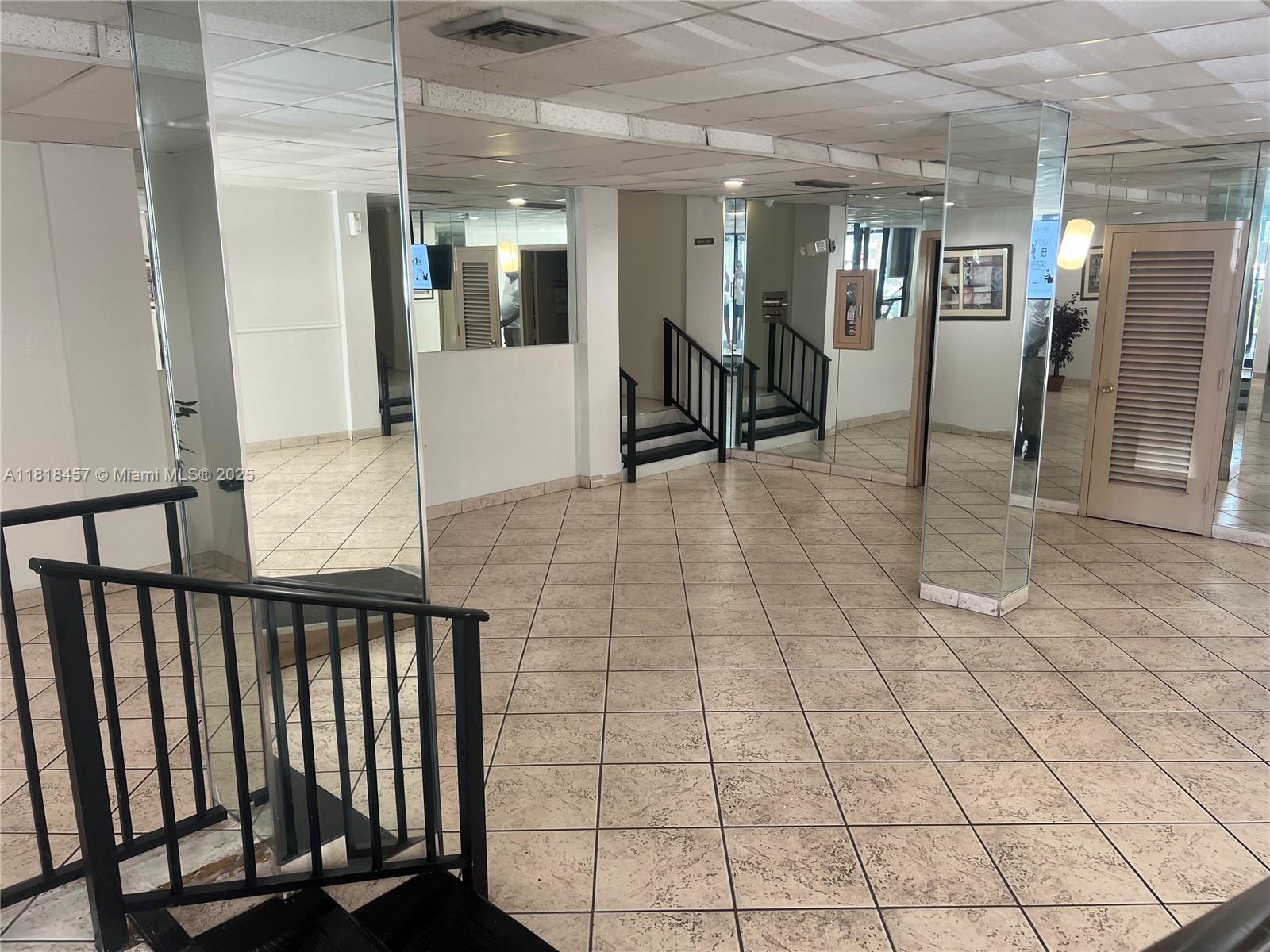 4156 Inverrary Drive, Unit 309 Lauderhill, FL 33319 - Photo 5 of 16 a view of a hallway with wooden floor and glass door