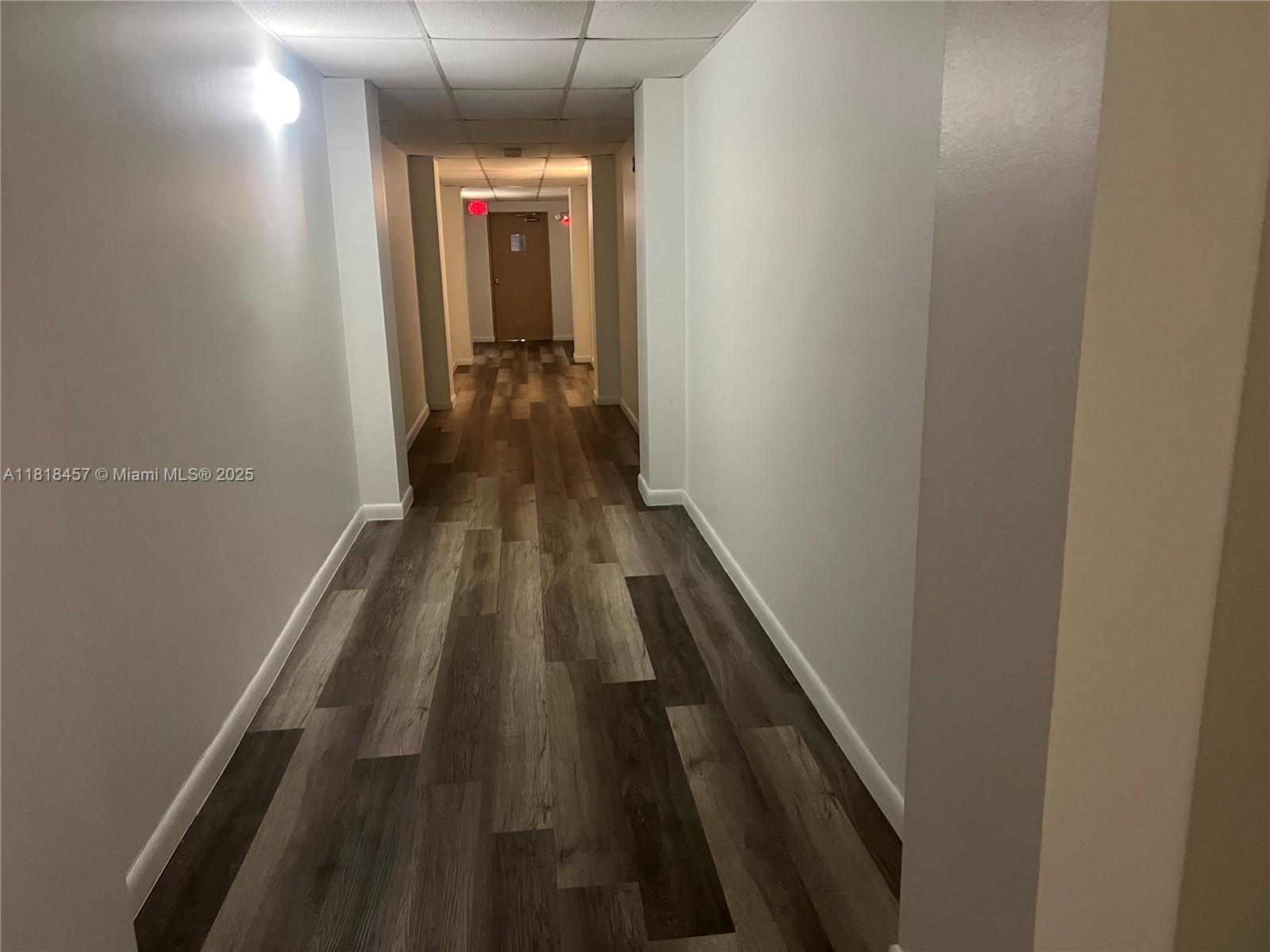 4156 Inverrary Drive, Unit 309 Lauderhill, FL 33319 - Photo 6 of 16 a view of a hallway with wooden floor and a bathroom