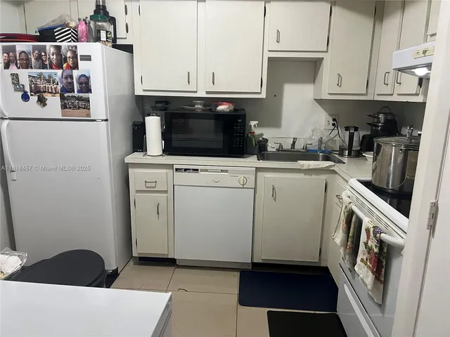 a kitchen with a sink and a stove top oven