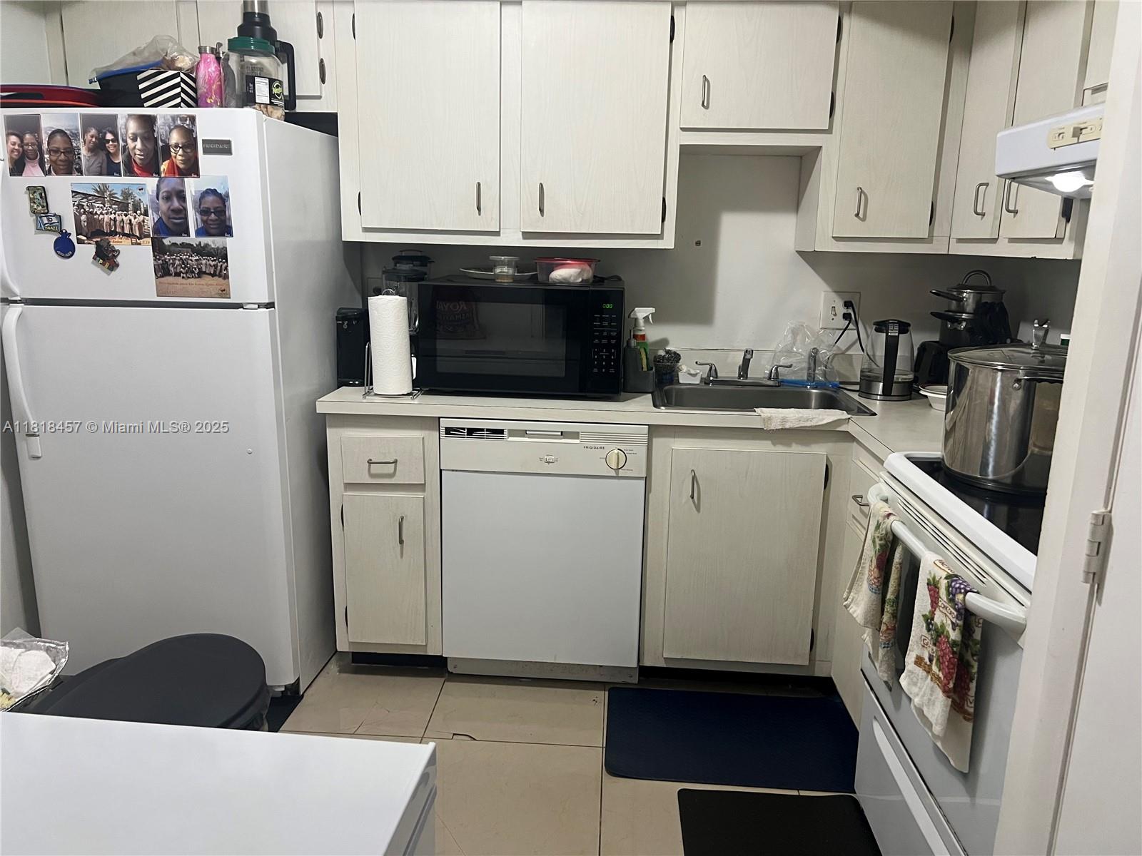 4156 Inverrary Drive, Unit 309 Lauderhill, FL 33319 - Photo 7 of 16 a kitchen with a sink and a stove top oven