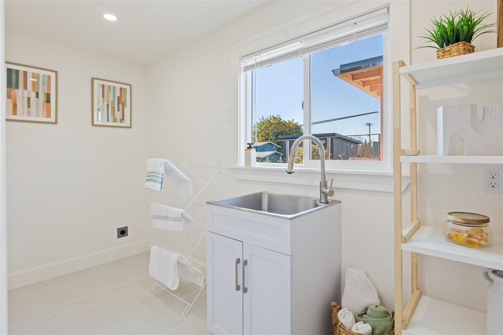 1524 Blake Street Berkeley, CA 94703 - Photo 21 of 59 Laundry area featuring electric dryer hookup, cabinet space, light tile patterned flooring, and recessed lighting