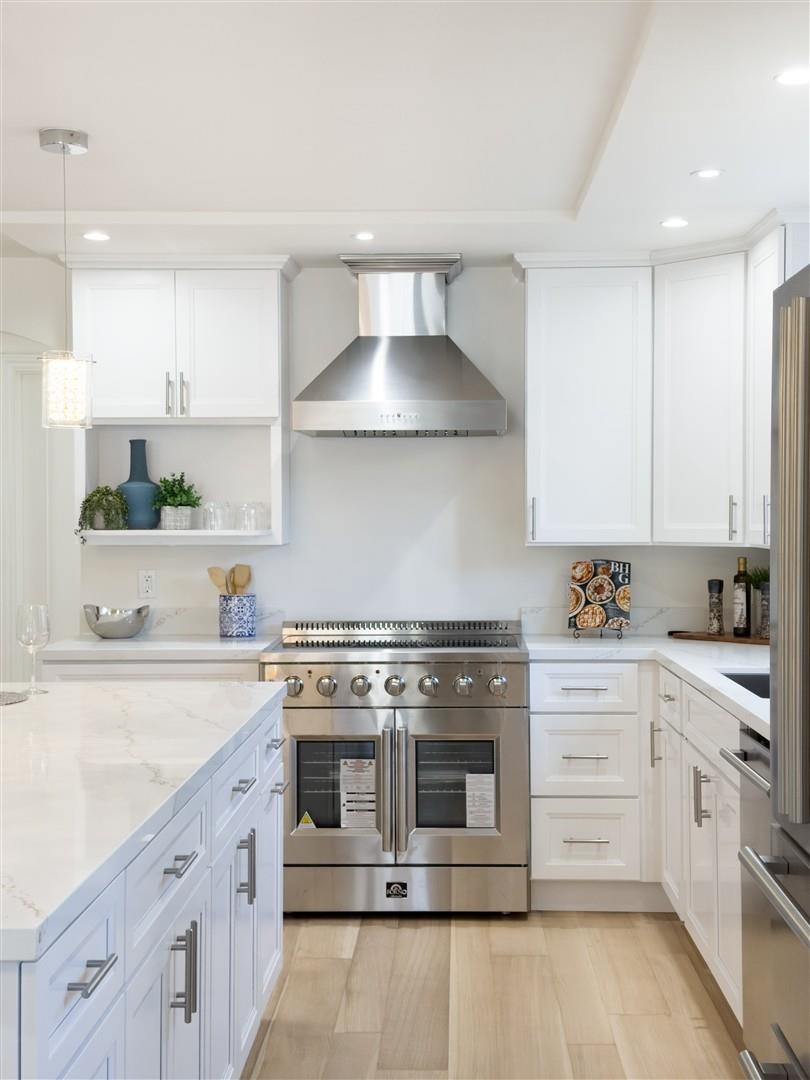 1524 Blake Street Berkeley, CA 94703 - Photo 35 of 59 Kitchen with premium appliances, wall chimney exhaust hood, white cabinets, pendant lighting, and recessed lighting