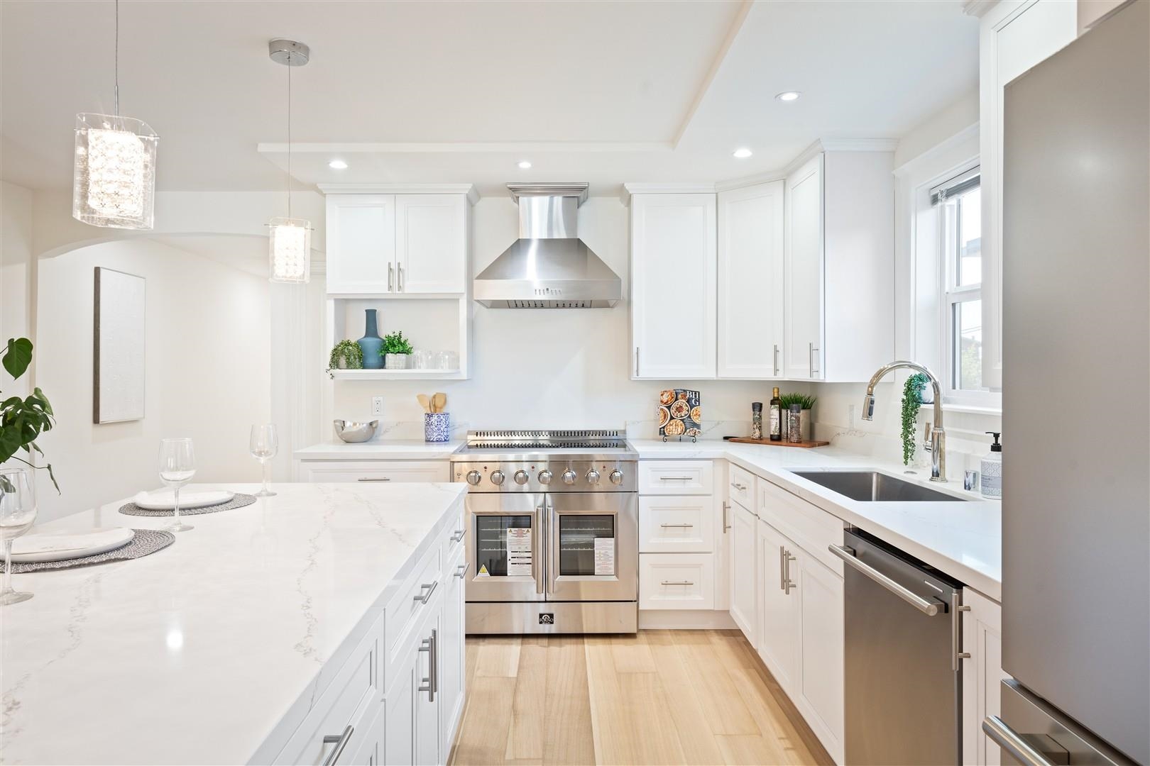 1524 Blake Street Berkeley, CA 94703 - Photo 36 of 59 Kitchen featuring appliances with stainless steel finishes, pendant lighting, white cabinetry, and recessed lighting