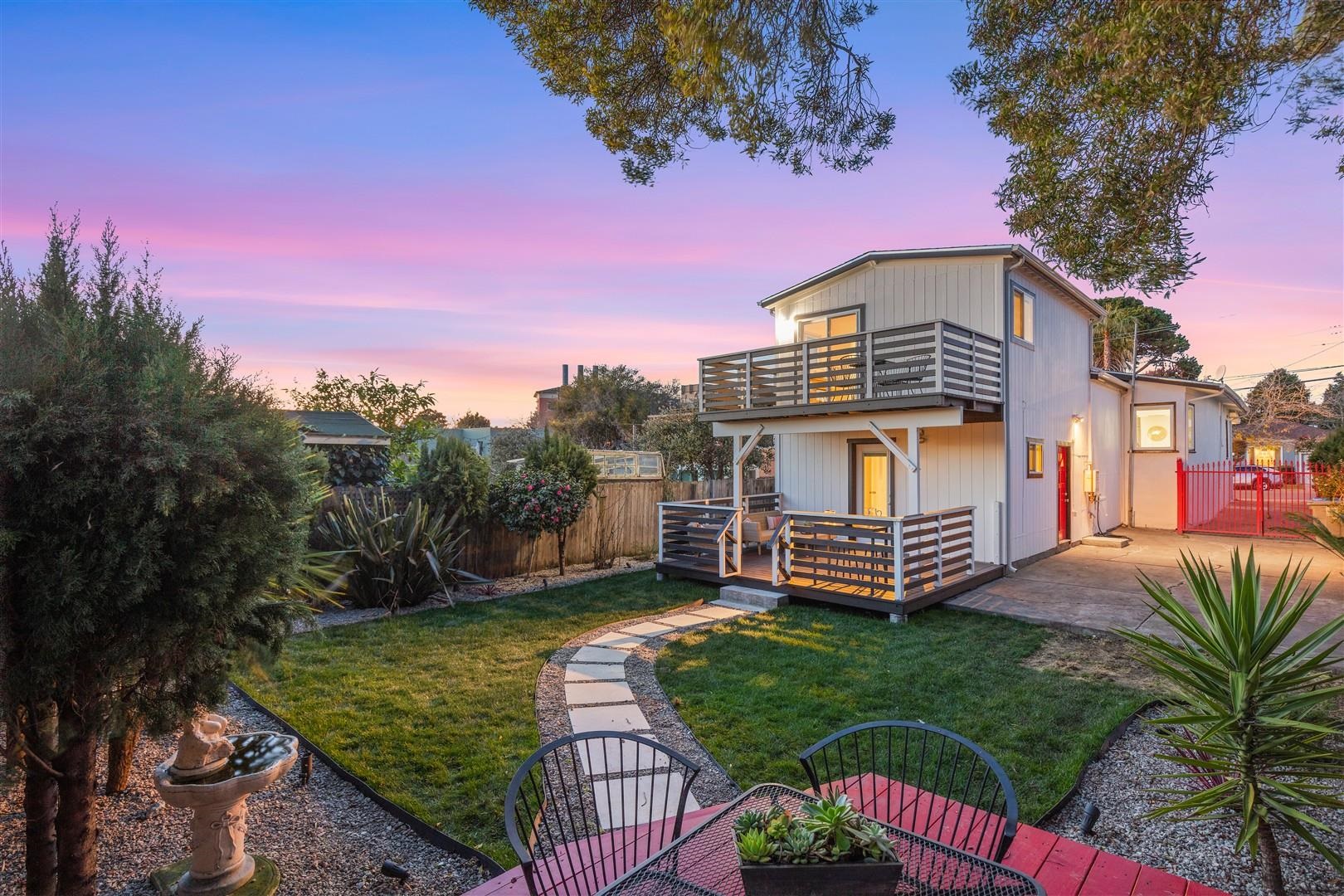 1524 Blake Street Berkeley, CA 94703 - Photo 6 of 59 Back of house at dusk featuring a fenced backyard and a wooden deck