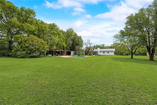 a view of yard with grass and trees
