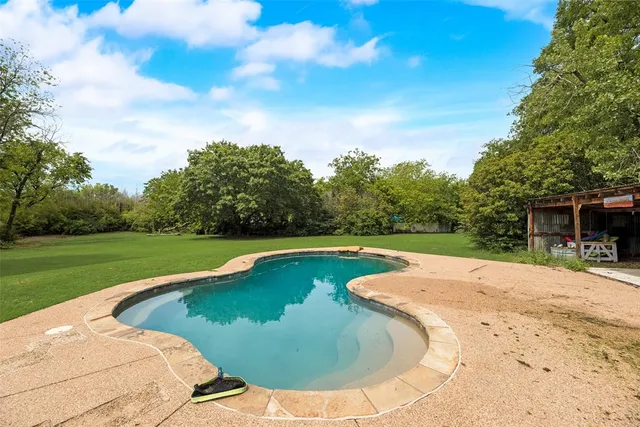 a view of a swimming pool with a yard