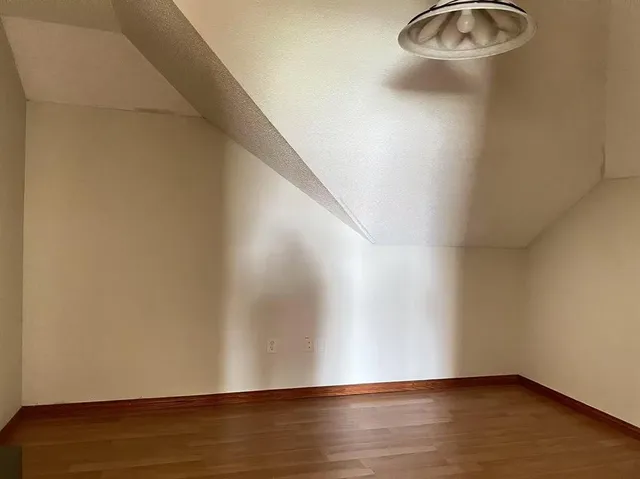 a view of water heater room with wooden floor