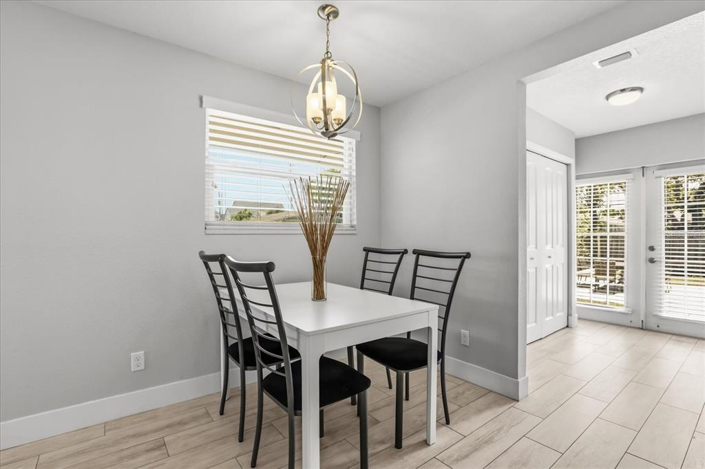 159 Holland Road Ormond Beach, FL 32176 - Photo 13 of 55 a view of a dining room with furniture and wooden floor