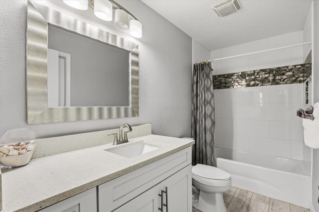 159 Holland Road Ormond Beach, FL 32176 - Photo 17 of 55 a bathroom with a sink a toilet and shower