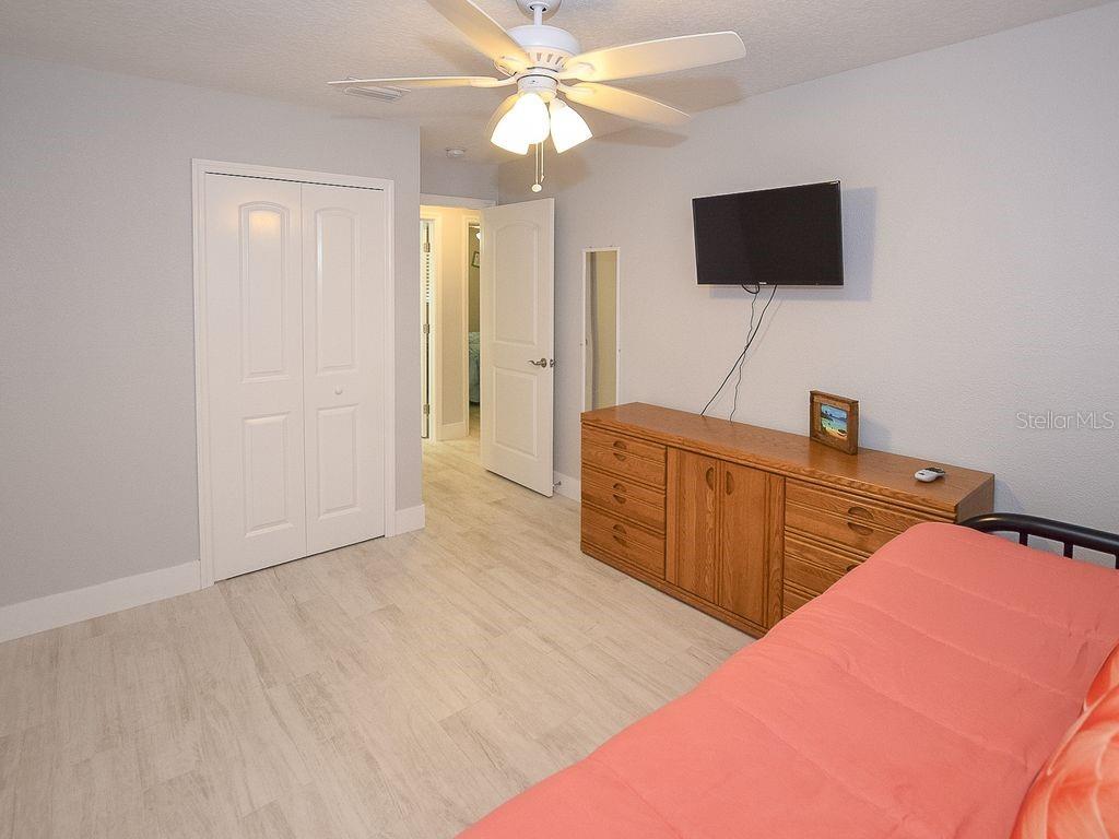 159 Holland Road Ormond Beach, FL 32176 - Photo 20 of 55 a bedroom with a bed and a flat screen tv