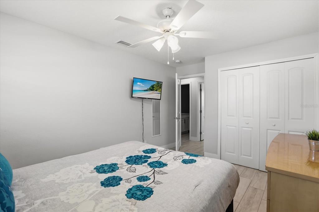 159 Holland Road Ormond Beach, FL 32176 - Photo 25 of 55 a bedroom with a bed and a chandelier