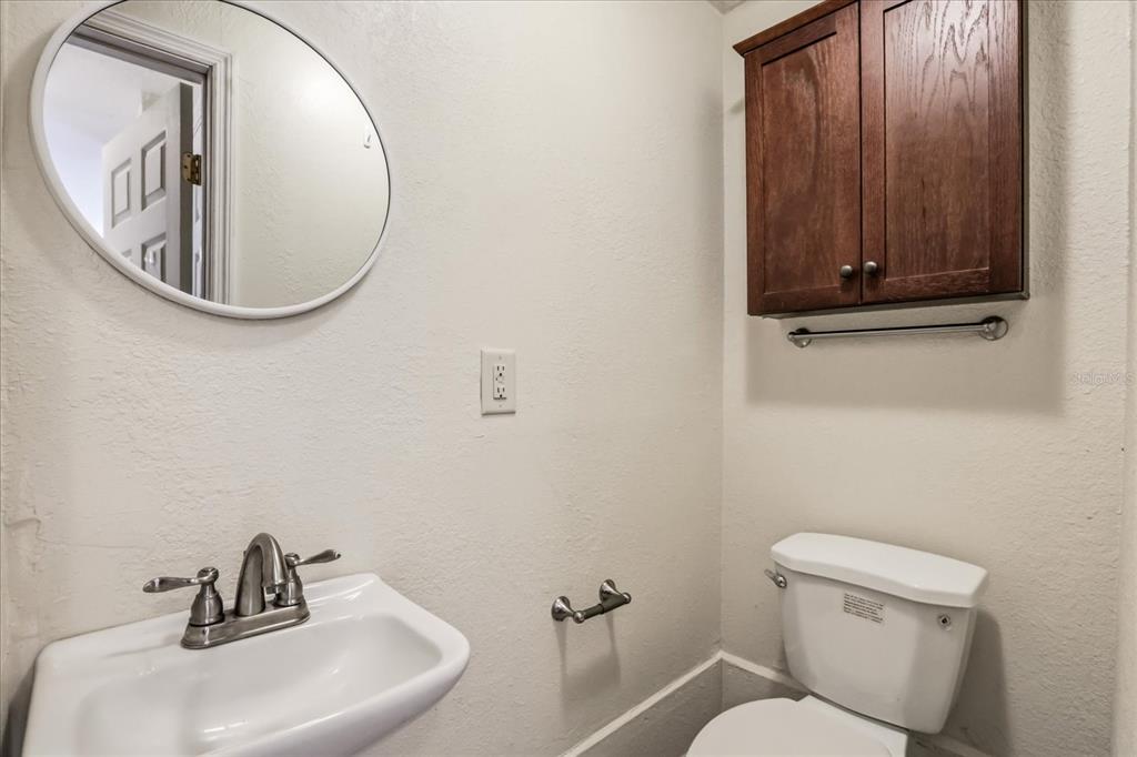 159 Holland Road Ormond Beach, FL 32176 - Photo 35 of 55 a bathroom with a toilet a sink and mirror