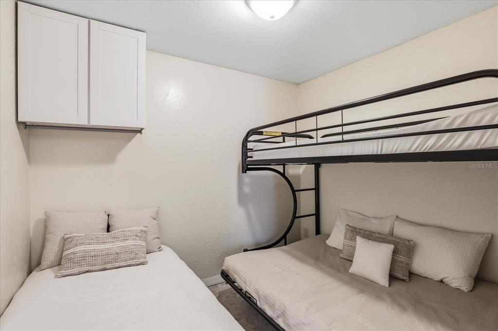 159 Holland Road Ormond Beach, FL 32176 - Photo 38 of 55 a bedroom with a bed and cabinets
