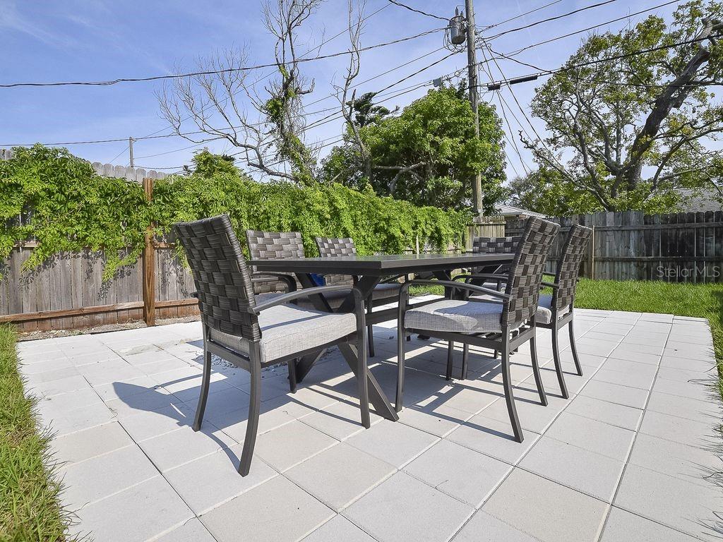 159 Holland Road Ormond Beach, FL 32176 - Photo 40 of 55 a view of a chairs and table in backyard