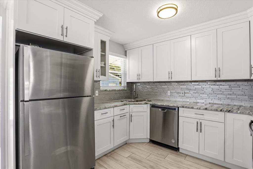 159 Holland Road Ormond Beach, FL 32176 - Photo 9 of 55 a white refrigerator freezer sitting inside of a kitchen