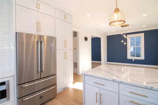 a kitchen with stainless steel appliances a refrigerator and a refrigerator
