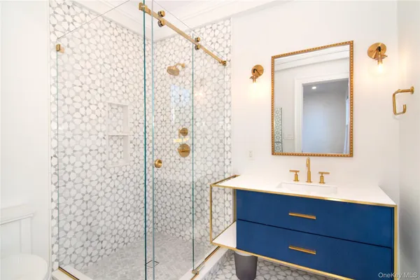 a bathroom with a shower a sink and a mirror
