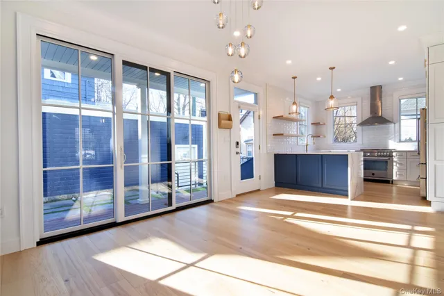 a view of kitchen and kitchen with granite countertop a large window