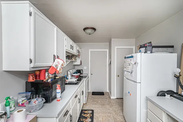 a kitchen with stainless steel appliances a refrigerator and a stove top oven