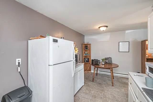 a white refrigerator freezer sitting in a kitchen