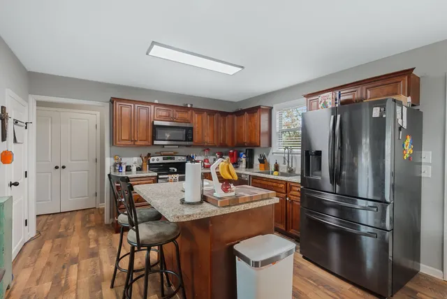a kitchen with stainless steel appliances granite countertop a refrigerator stove top oven a sink and dishwasher