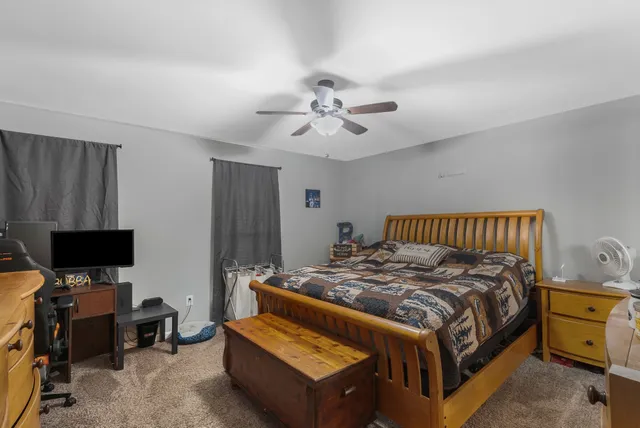 a bedroom with a bed and a television